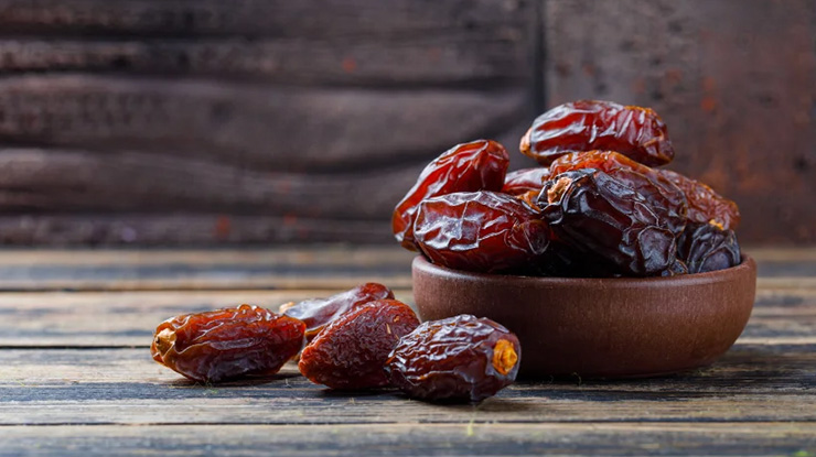 sweet-dates-clay-plate-stone-tile-wooden-background